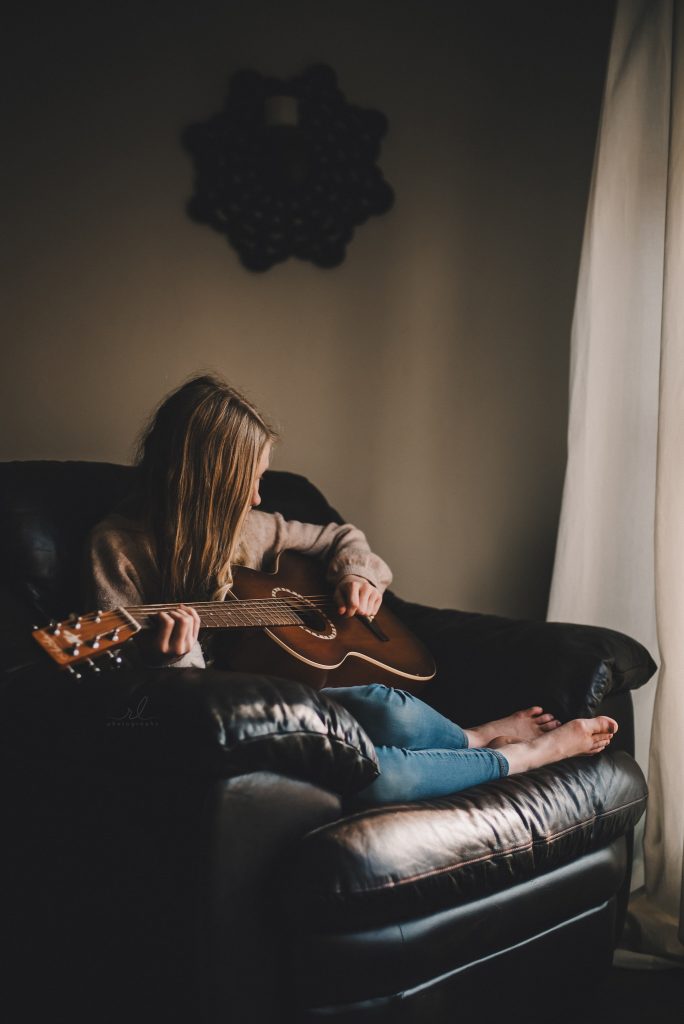 RL Photography OKC taking photos of teen with guitar